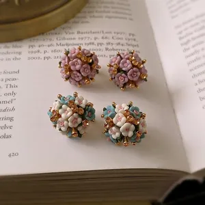 Floral cluster earrings with ceramic flowers and rhinestones on vintage book pages