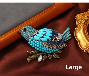 Detail of vintage blue crystal magpie brooch on silk fabric, large size bird accessory
