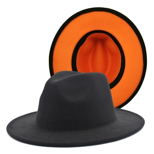 Detail of classic black wool fedora featuring a vibrant orange brim interior and inner lining