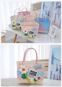 Close-up of handmade woven picnic bag with 3D felt flowers and Good Luck patch details
