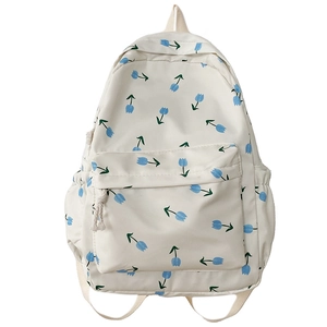Minimalist white canvas floral backpack with blue tulips and green stems patterns
