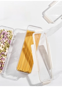 Stackable food-grade plastic pasta storage containers with airtight white lids on marble surface