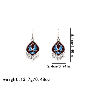 Detail view of retro ethnic drop earrings with size specs and silver tassels