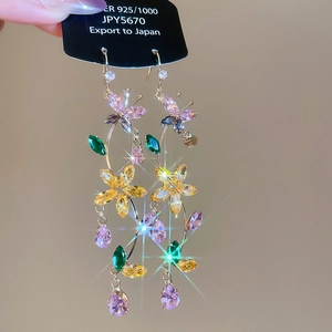 Detail of 925 silver butterfly flower tassel earrings with multi-colored crystals