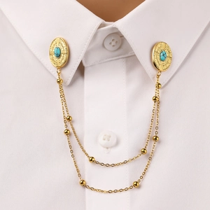 Oval turquoise gold collar pin with double chains on a white shirt collar