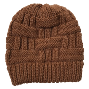 Macro detail of brown chunky knit beanie showing textured basket weave pattern and ribbed cuff