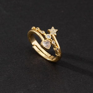 Detail of adjustable gold ring featuring heart and star-shaped cubic zirconia stones