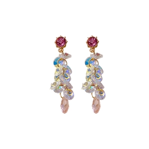 Elegant gold drop earrings with pink gems and iridescent tassels on white background