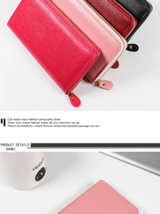 Detailed close-up showing the pebbled leather texture and golden metal zippers of the wallet