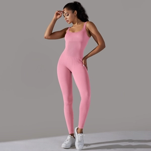 Detailed close-up of pink ribbed seamless yoga jumpsuit fabric and tight fit design