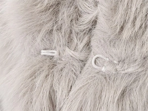 Macro shot of invisible hook closure on light gray faux fur hooded coat detail