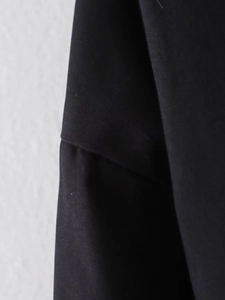 Macro shot of durable black woven fabric texture and seam details on pilot jacket