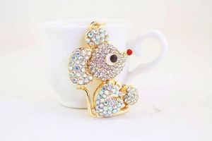 Close-up of golden mouse keychain with colorful rhinestones and red nose detail