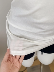 Close-up of breathable white Tencel wool fabric showing its lightweight texture
