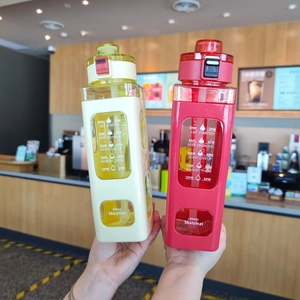 Detail of 900ml square plastic sports bottles with time markers and straw in red and yellow
