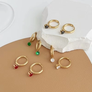 Detail view of four pairs of gold hoop earrings with multi-color gemstone pendants