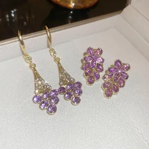 Violet flower crystal drop earrings and studs set in gold finish with diamond accents
