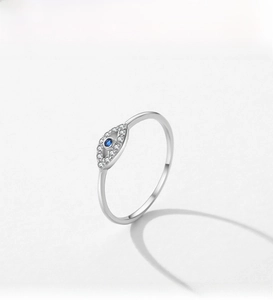 Macro shot of silver Evil Eye ring with blue gemstone and white zircon setting