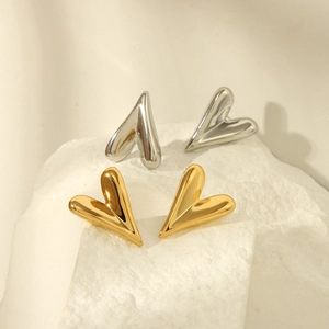 Polished 18K gold and silver heart-shaped titanium steel stud earrings on stone