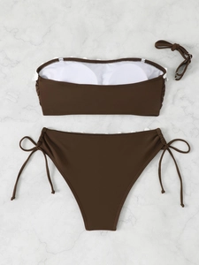 Flat lay of dark brown bandeau bikini set with removable pads and side-tie details