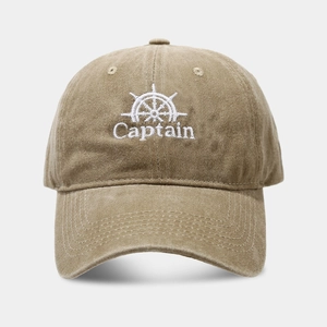 Close-up of khaki vintage baseball cap with white captain and helm embroidery details