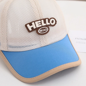 Detail of breathable white mesh fabric and HELLO 3D embroidery on kids baseball cap