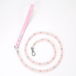 Detail of luxury pink pearl pet leash with rhinestone accents and leather handle