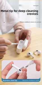 Close-up of a multi cleaning pen removing debris from wireless earbud charging case