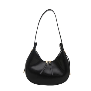 Glossy black half-moon hobo bag with dual gold zippers and stylish crescent design