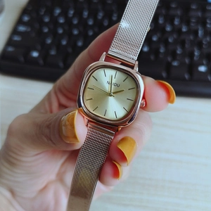 Close-up of rose gold square quartz watch with a metal mesh strap for stylish women