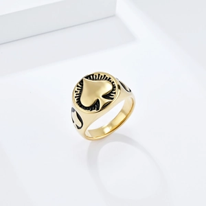 Detailed shot of gold ace of spades signet ring with black embossed radial line patterns