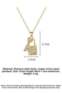 Close-up of gold heart key and lock necklace showing 40cm chain and 2.7cm pendant size