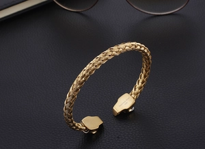 Detail of 316L stainless steel engraving on golden braided skull cuff bracelet