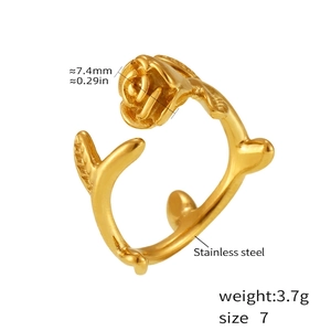Macro shot of gold-plated rose flower ring showing 7.4mm floral head and steel texture