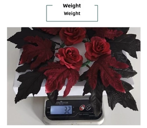 Detail view of gothic Halloween candle wreath with black maple leaves, weighing 32 grams