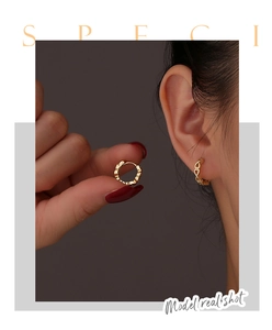 Detailed close-up of gold hollow heart hoop earrings featuring elegant cutout patterns