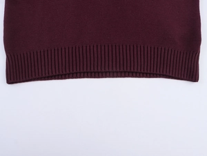 Detail shot of the ribbed hem on this burgundy crew neck knitted cropped sweater