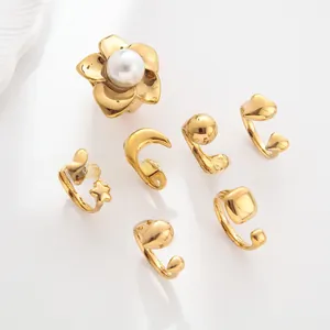 Detailed set of 7 gold plated rings featuring pearl flower and geometric charms