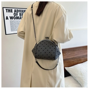 Gray polka dot embroidery shell bag with black metal chain shown on model back