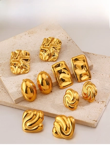 Close-up of assorted 18K gold plated geometric earrings on natural stone display stand