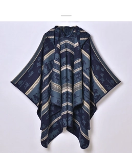 Close-up of thick ethnic blue hooded poncho with striped patterns and jacquard details