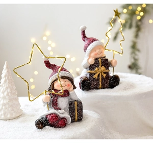 Close-up of resin Christmas figures with LED light frames and festive glitter finish