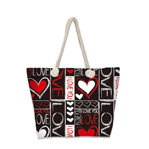 Detail of canvas beach tote with heart patterns and thick woven rope handle