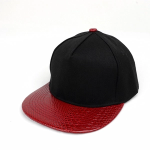 Close-up of hip hop hat with black twill crown and red faux crocodile leather flat brim