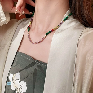 Close-up of elegant beaded necklace featuring multi-colored irregular glass stones