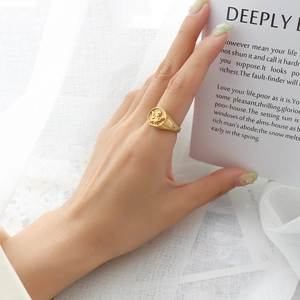 Vintage 18k gold plated angel relief signet ring for women shown on hand