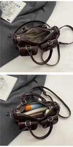 Detailed macro view showing the spacious interior and pockets of the dark brown leather bag
