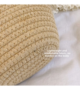 Close-up of woven straw texture and dense spiral stitching on khaki shoulder bag