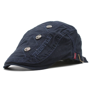 Close-up of navy blue cotton ivy cap with Freestyle embroidery and metallic rivets