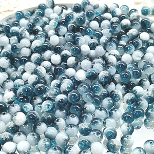 Macro shot of 10mm blue and white gradient cracked glass beads for DIY jewelry making